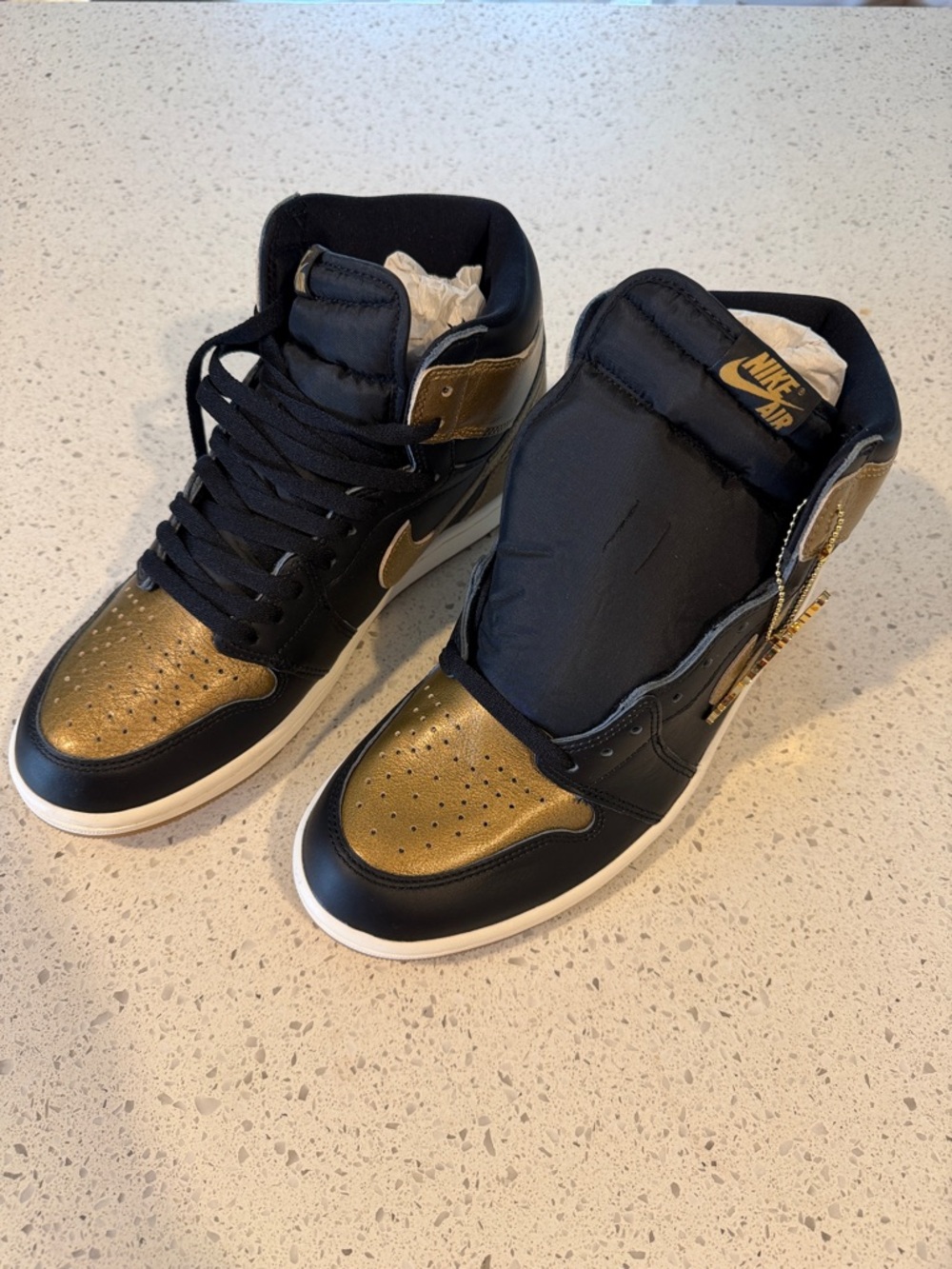 Nike Air Jordan 1 High Top Sneakers in Black and Gold